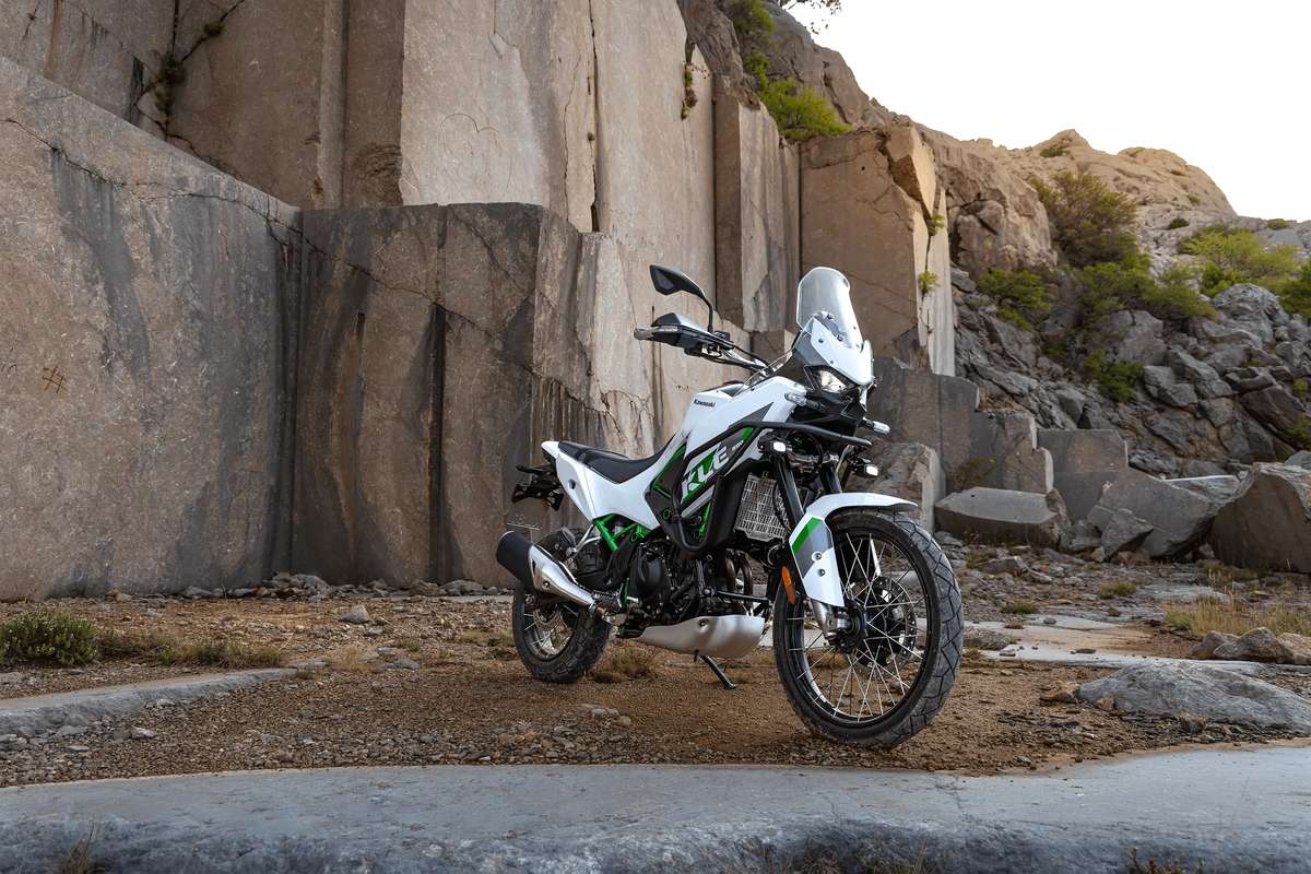 2027 Kawasaki KLE500 SE Smartride ABS in Pearl Blizzard White with green trellis frame parked in a rocky stone quarry