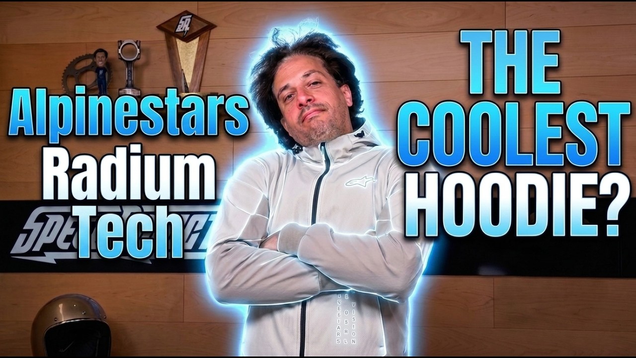 Adam Waheed wearing a light gray Alpinestars Radium Tech protective motorcycle hoodie with 'The Coolest Hoodie?' text