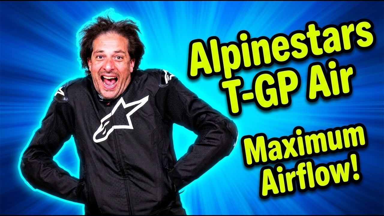 Adam Waheed smiling in a black Alpinestars T-GP Air textile motorcycle jacket with 'Maximum Airflow!' text